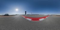 a 360 - angle view of a track, with the sun in the distance, looking at the ground