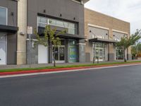 a large commercial store front with no parking at all along the street side and red curb