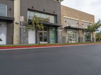 a large commercial store front with no parking at all along the street side and red curb