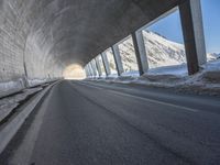 the tunnel is made up of concrete and beams it provides light and darkness, as can the snow