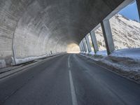 the tunnel is made up of concrete and beams it provides light and darkness, as can the snow