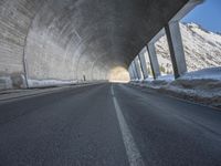 the tunnel is made up of concrete and beams it provides light and darkness, as can the snow