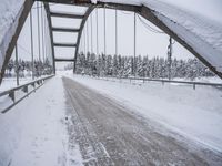 a large bridge is surrounded by deep snow in the winter day and is very visible in the photograph