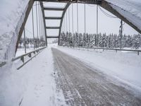 a large bridge is surrounded by deep snow in the winter day and is very visible in the photograph