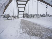 a large bridge is surrounded by deep snow in the winter day and is very visible in the photograph