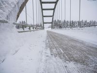 a large bridge is surrounded by deep snow in the winter day and is very visible in the photograph