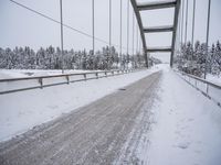 a large bridge is surrounded by deep snow in the winter day and is very visible in the photograph