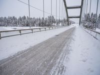 a large bridge is surrounded by deep snow in the winter day and is very visible in the photograph