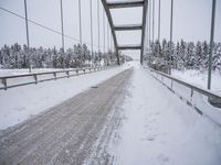 a large bridge is surrounded by deep snow in the winter day and is very visible in the photograph