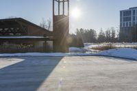 a church with snow on the ground and a big clock tower standing in front of it