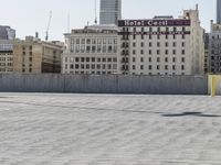 a man on a skate board that is standing in front of some buildings and buildings