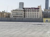 a man on a skate board that is standing in front of some buildings and buildings