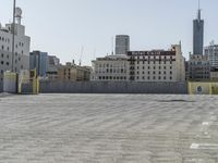 a man on a skate board that is standing in front of some buildings and buildings