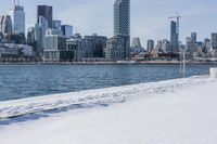 this is a cityscape view of a winter city area with buildings over the water