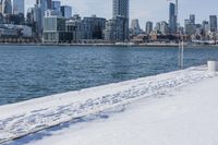 this is a cityscape view of a winter city area with buildings over the water