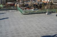 a view of the town in winter from a roof top balcony of a building with a wrought fence in front