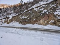 a mountain is shown covered by snow in this undbersized view of the road