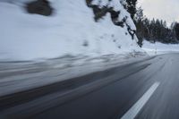 a car is driving on the snow covered road in the winter hours of this time of day