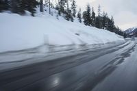 a car is driving on the snow covered road in the winter hours of this time of day