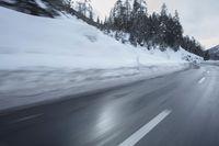 a car is driving on the snow covered road in the winter hours of this time of day