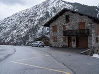 a car is parked outside of the mountain lodge for cars to travel in to get there