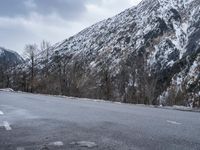 there is snow on the mountain side of the road to give a pleasant view of this mountainous area