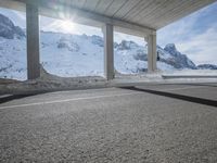 the view from under the road, looking out towards the mountains of which is covered with snow