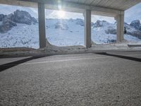 the view from under the road, looking out towards the mountains of which is covered with snow