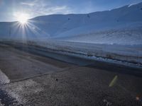 a ski slope is in the winter as the sun shines in the sky above