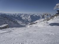 the mountains are covered in snow with a skier coming down a steep mountain side to the bottom