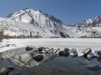 Winter landscape with snow-covered mountains and lake
