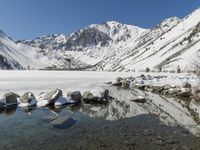 Winter landscape with snow-covered mountains and lake