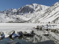 Winter landscape with snow-covered mountains and lake