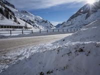 snow on the road is very deep and snowy on the mountain slopes of the alps