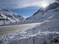 snow on the road is very deep and snowy on the mountain slopes of the alps