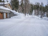 there is snow covering a roof and a garage by it's entrance to the house