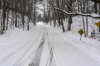 a road filled with snow and a yellow sign with an arrow pointing up to the road