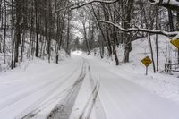 a road filled with snow and a yellow sign with an arrow pointing up to the road