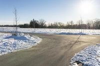 a picture of the snow on the road is clear and there is a white building in the distance