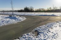 a picture of the snow on the road is clear and there is a white building in the distance