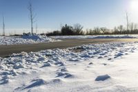 a picture of the snow on the road is clear and there is a white building in the distance