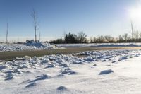 a picture of the snow on the road is clear and there is a white building in the distance