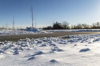 a picture of the snow on the road is clear and there is a white building in the distance