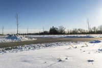 a picture of the snow on the road is clear and there is a white building in the distance