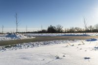 a picture of the snow on the road is clear and there is a white building in the distance