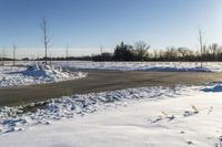 a picture of the snow on the road is clear and there is a white building in the distance