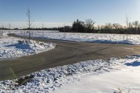 a picture of the snow on the road is clear and there is a white building in the distance