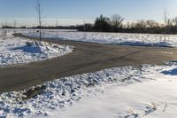 a picture of the snow on the road is clear and there is a white building in the distance