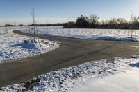 a picture of the snow on the road is clear and there is a white building in the distance