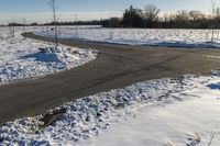 a picture of the snow on the road is clear and there is a white building in the distance